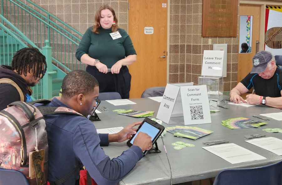 Taylor standing at comment table